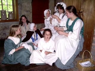 Young Pioneers taking a sewing lesson